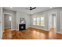 Inviting living room with hardwood floors, a fireplace, and natural light from large windows at 224 Wash Hollow Dr, Wendell, NC 27591