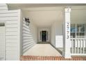 Inviting front porch with white columns and brick flooring at 2773 Clifton Avenue, Creedmoor, NC 27522