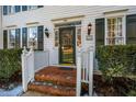 Front entrance with brick steps, green door and white railings at 3 Acornridge Ct, Durham, NC 27707