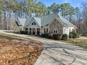 Charming ranch style home features stone accents, inviting front porch, and long driveway at 413 Johnson Town Rd, Zebulon, NC 27597