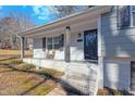 Inviting front porch with white brick and a wooden bench at 420 W 10Th St, Siler City, NC 27344