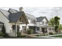 Stunning house exterior boasts a spacious backyard, stone patio, and walkway at 432 Firefly Overlook, Pittsboro, NC 27312