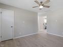 Open living room with wood-look floors and a view into the kitchen at 609 E Cockrell St, Nashville, NC 27856