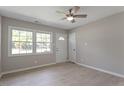 Living room with wood-look floors, neutral walls and a door to the outside at 609 E Cockrell St, Nashville, NC 27856