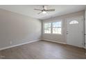 Bright living room with neutral walls, wood-look floors, and a ceiling fan at 609 E Cockrell St, Nashville, NC 27856