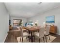 Open dining area with wood flooring, a modern table set, and deck access at 635 Pine Ridge Pl, Raleigh, NC 27609