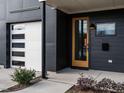 Modern house entrance with a sleek orange door and black siding at 707 Colleton Rd, Raleigh, NC 27610