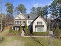 Two-story house with stone and shingle accents, landscaping, and a welcoming front porch at 7112 Hasentree Way, Wake Forest, NC 27587