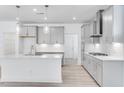 Stylish kitchen with gray cabinets, stainless steel appliances, and a sleek backsplash at 804 Heathered Farm Way, Apex, NC 27523