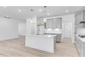 Modern kitchen featuring white cabinets, stainless steel appliances, and an island at 804 Heathered Farm Way, Apex, NC 27523