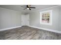 Bedroom featuring wood-look floors, fresh paint, ceiling fan, and a bright window at 925 Redgate Ave, Rocky Mount, NC 27801