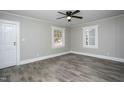 Spacious living room with wood-look floors, ceiling fan, and ample natural light at 925 Redgate Ave, Rocky Mount, NC 27801