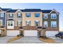 Attractive townhomes with diverse siding, complementary shutters and brick bases provide visual interest at 104 Ridgeline Ct, Durham, NC 27703