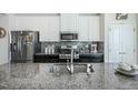 Modern kitchen with granite countertops and stainless steel appliances at 104 Ridgeline Ct, Durham, NC 27703