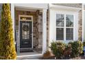 Inviting front entrance with stone accents and a charming wreath at 1109 Timbercut Dr, Durham, NC 27703