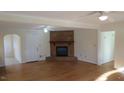Spacious living room with hardwood floors and brick fireplace at 1202 Vandora Ave, Garner, NC 27529