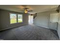 Spacious living room with gray carpeting and neutral walls at 16 Shiloh Dr, Lillington, NC 27546