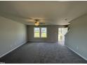 Bright living room featuring neutral walls and gray carpeting at 16 Shiloh Dr, Lillington, NC 27546