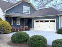 Attractive home with a two-car garage and a welcoming front porch with chairs at 241 Serenity Hill Cir, Chapel Hill, NC 27516
