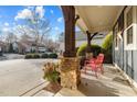 Inviting front porch with stone pillars and comfortable seating for relaxing outdoors at 241 Serenity Hill Cir, Chapel Hill, NC 27516