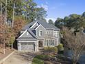 Two-story house with gray siding, a large driveway, and a landscaped lawn at 2500 Shadow Hills Ct Ct, Raleigh, NC 27612