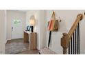 Bright entryway with a console table, bench, and staircase at 263 Hanging Elm Ln, Fuquay Varina, NC 27526
