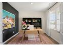 Home office with a large desk, built-in shelving, and a window at 263 Hanging Elm Ln, Fuquay Varina, NC 27526