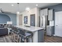 Kitchen island with seating and stainless steel refrigerator at 287 Broomside Ave, Raleigh, NC 27603