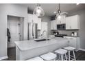Modern kitchen with white cabinets, stainless steel appliances, and large island at 291 Broomside Ave, Raleigh, NC 27603