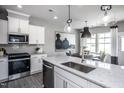 Modern kitchen with white cabinets, stainless steel appliances, and breakfast bar at 291 Broomside Ave, Raleigh, NC 27603