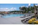 Community pool with lounge chairs and umbrellas at 333 Broomside Ave, Raleigh, NC 27603