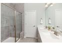 Spa-like bathroom with double vanity, large shower, and modern fixtures at 341 Broomside Ave, Raleigh, NC 27603