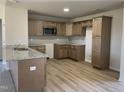 Modern kitchen with light wood cabinets and granite countertops at 39 Harvest Hills Ln, Dunn, NC 28334