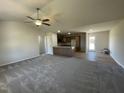 Open living room and kitchen with neutral colors and carpet at 39 Harvest Hills Ln, Dunn, NC 28334