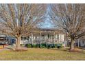 White house with green trim, and a spacious front yard at 505 Forrest St, Hillsborough, NC 27278