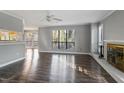 Living room with hardwood floors, fireplace and large windows at 514 New Kent Pl, Cary, NC 27511