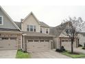 Two-story townhome with stone and siding exterior, two-car garage, and landscaping at 524 Brunello Dr, Wake Forest, NC 27587