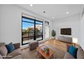 Bright living room featuring hardwood floors, a large window, and neutral-toned furniture at 615 Daniels St # 316, Raleigh, NC 27605