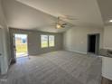 Spacious living room with high ceilings, carpeting, and neutral color palette at 63 Harvest Hills Ln, Dunn, NC 28334