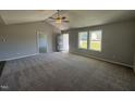 Spacious living room with high ceilings, carpeting, and neutral color palette at 63 Harvest Hills Ln, Dunn, NC 28334