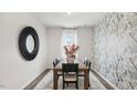 Elegant dining room with wood table, statement wall, and mirror at 64 Tributary Way, Fuquay Varina, NC 27526