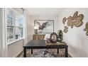 Home office features a desk, window, and decorative wall art at 64 Tributary Way, Fuquay Varina, NC 27526