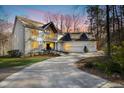 Beautiful two-story home with white exterior and ample parking in the driveway during dusk at 811 Oxbow Crossing Rd, Chapel Hill, NC 27516