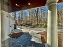 Covered front porch with bluestone tile flooring and view of the front yard at 811 Oxbow Crossing Rd, Chapel Hill, NC 27516
