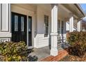 Charming front porch with black front door and white columns at 105 Wohler Ct, Cary, NC 27513