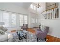 Bright living room with soaring ceilings, large windows, and comfortable seating at 105 Wohler Ct, Cary, NC 27513