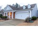 Two-story home with gray siding, white trim, and a two-car garage at 135 Abbey View Way, Cary, NC 27519