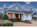 Gray siding, white trim, two-car garage, and manicured landscaping at 135 Abbey View Way, Cary, NC 27519