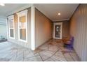 Covered front porch with flagstone flooring and wooden bench at 135 Abbey View Way, Cary, NC 27519