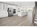 Modern kitchen featuring white cabinets, stainless steel appliances, and an island at 1368 Chowan Ave, Durham, NC 27713